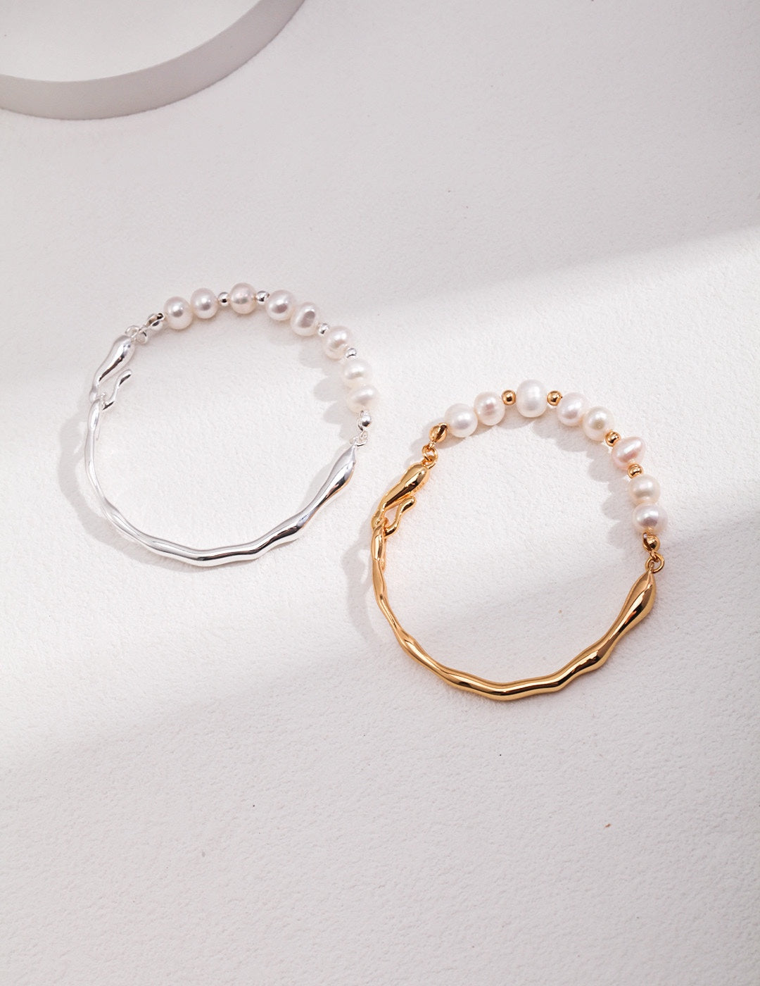 Vintage-gold sterling silver bracelet with natural pearls, small metal beads and an irregular fluid band.