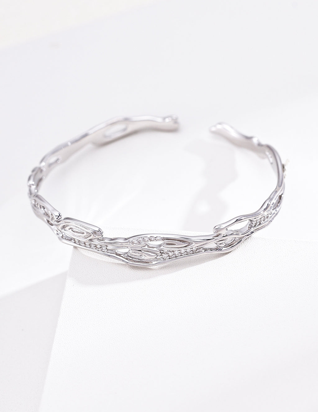 Sterling silver chain bracelet with spaced cubic zirconia accents and an airy adjustable design.