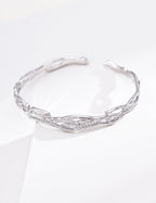 Sterling silver chain bracelet with spaced cubic zirconia accents and an airy adjustable design.