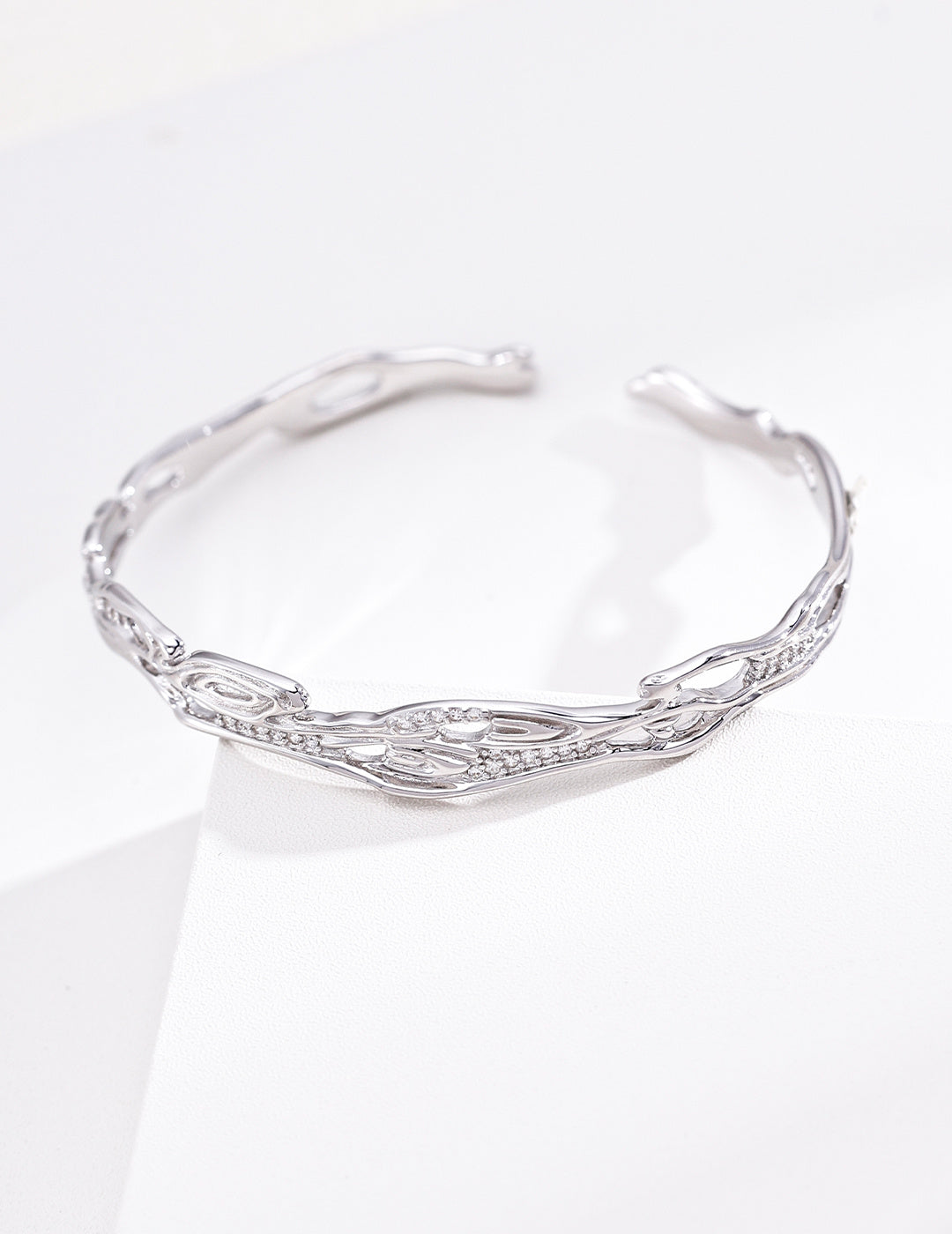 Sterling silver chain bracelet with spaced cubic zirconia accents and an airy adjustable design.