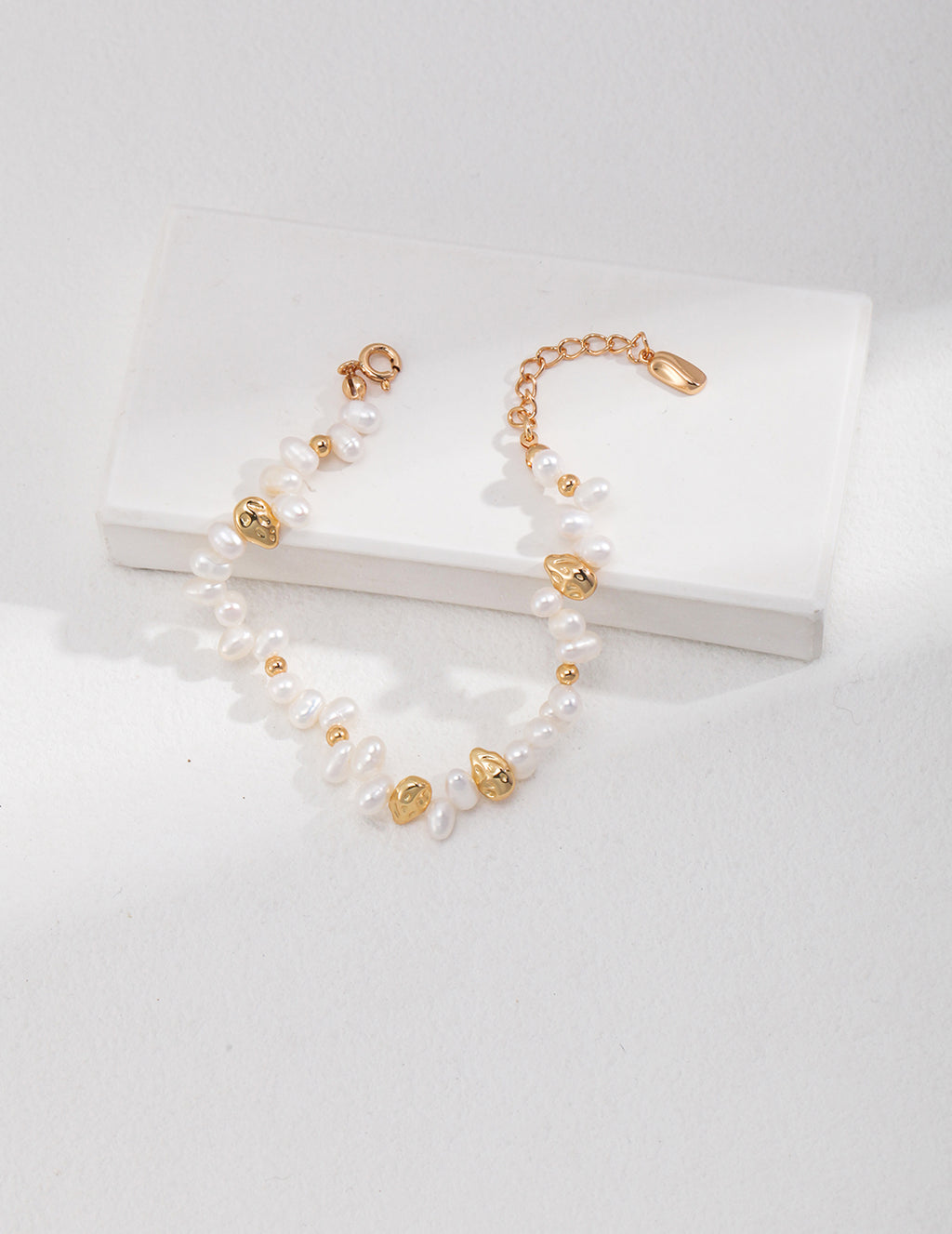 Vintage-gold sterling silver bracelet with small natural pearls, polished beads and larger irregular metal forms.