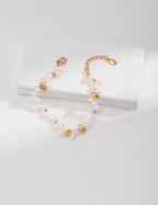 Vintage-gold sterling silver bracelet with small natural pearls, polished beads and larger irregular metal forms.