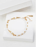 Vintage-gold sterling silver bracelet with natural pearls, polished beads and tapered metal elements arranged asymmetrically.