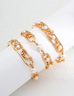 Vintage-gold sterling silver bracelet with natural pearls, open rectangular elements and branching metal forms.