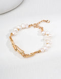 Vintage-gold sterling silver bracelet with irregular natural pearls, fluid-shaped metal elements and a fine bead-chain detail.