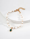 Vintage-gold sterling silver bracelet with irregular natural pearls and an oval green malachite centerpiece in an irregular metal surround.
