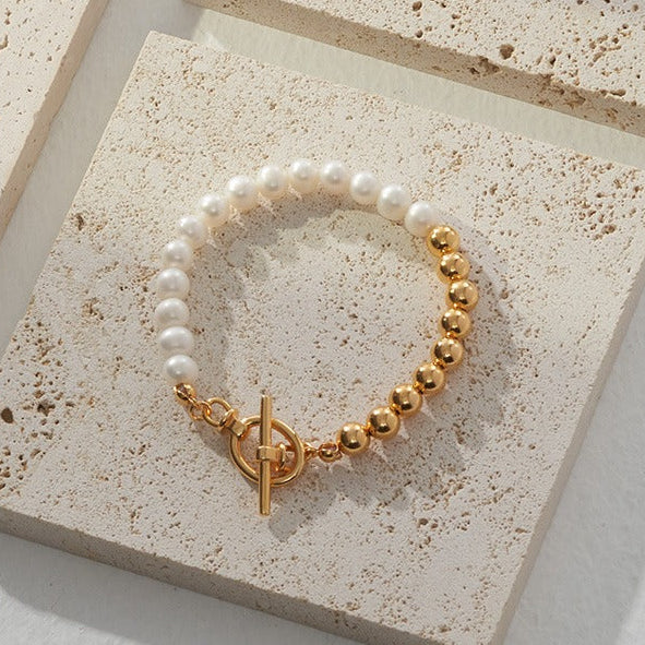 Vintage-gold sterling silver bracelet with natural pearls arranged in a restrained beaded composition.