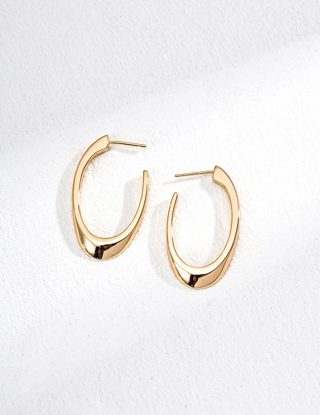 Vintage-gold sterling silver elongated open hoop earrings with a smooth tapered curve.