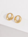 Vintage-gold sterling silver earrings with oval mother-of-pearl centers, textured borders and softly irregular metal surrounds.