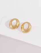 Vintage-gold sterling silver earrings with oval mother-of-pearl centers, textured borders and softly irregular metal surrounds.