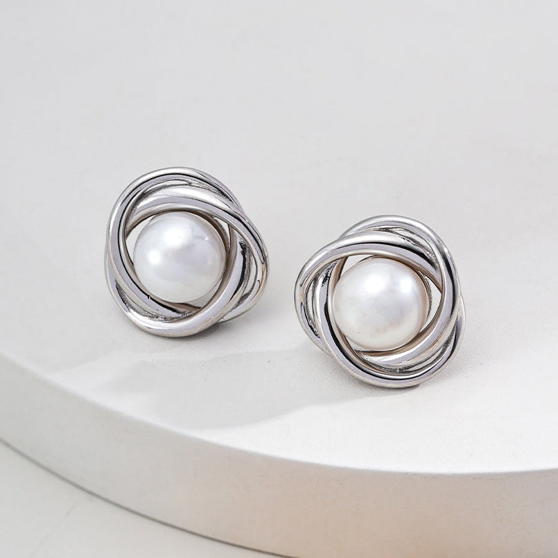 Vintage-gold sterling silver earrings with central natural pearls surrounded by overlapping curved metal bands.