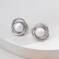 Vintage-gold sterling silver earrings with central natural pearls surrounded by overlapping curved metal bands.