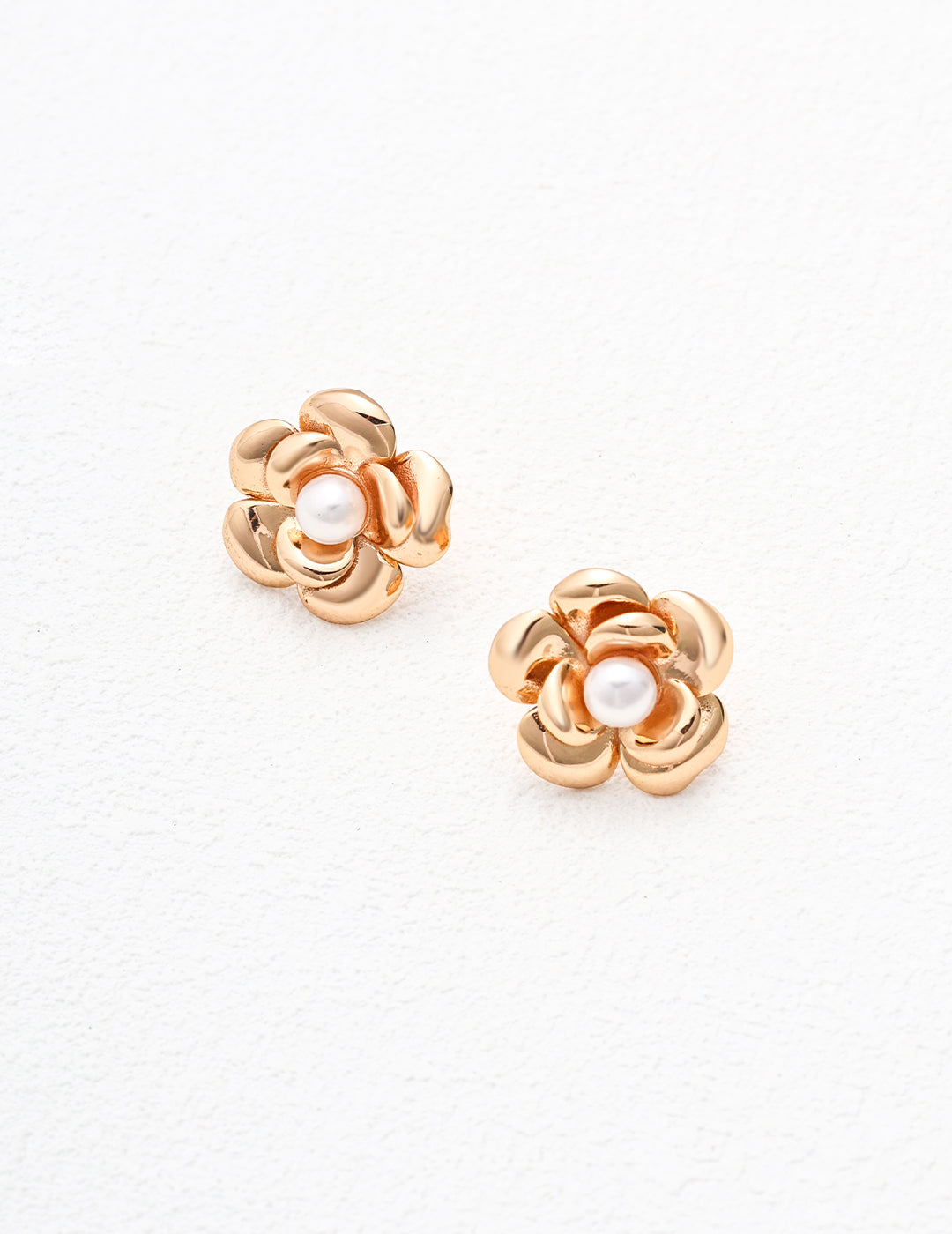 Vintage-gold sterling silver floral earrings with layered rounded petals surrounding a central natural pearl.