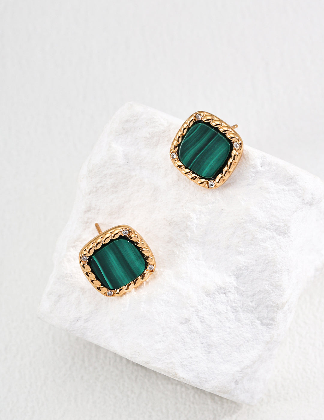 Vintage-gold sterling silver stud earrings with rounded-square green malachite centers, textured borders and small clear zircon accents.