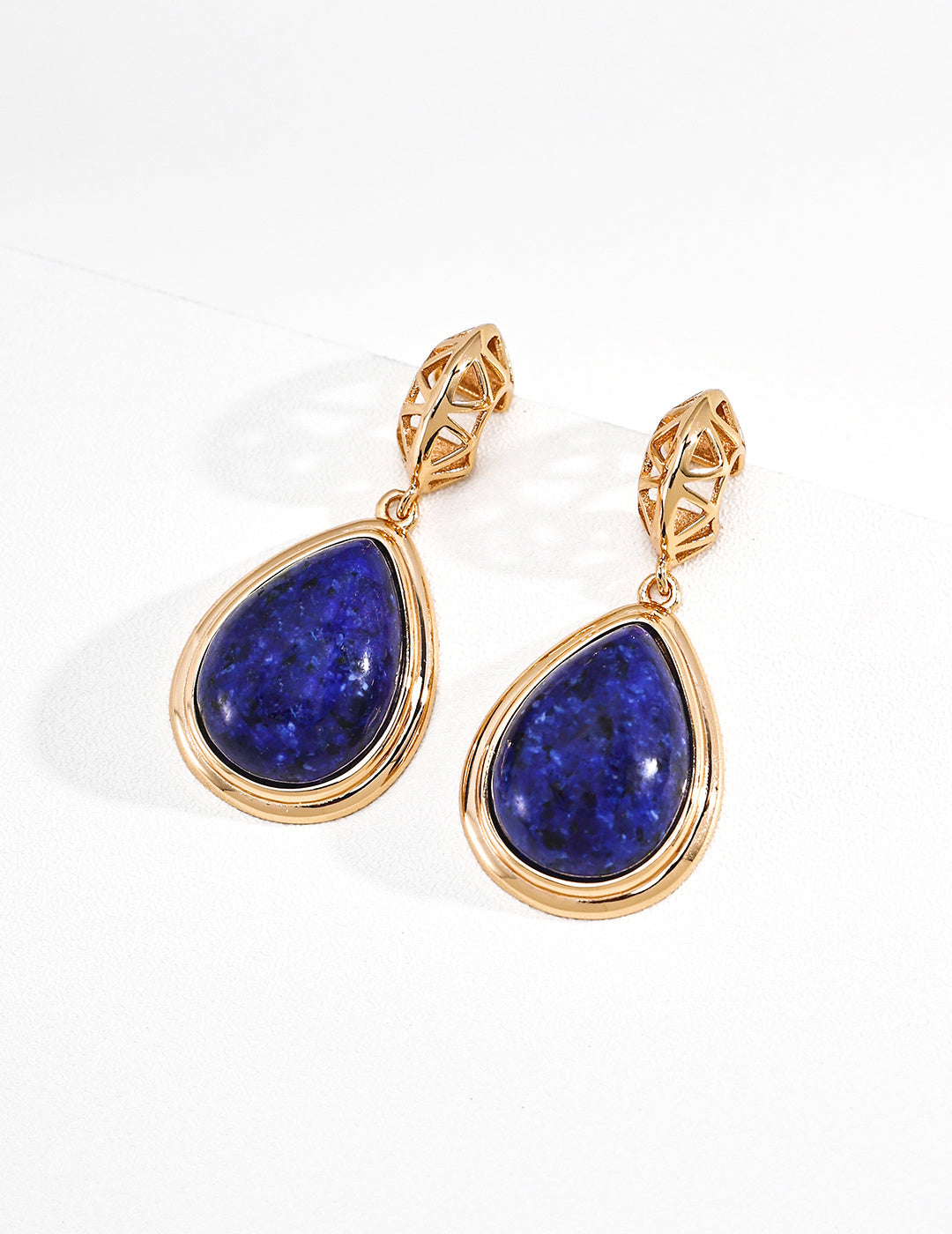 Vintage-gold sterling silver drop earrings with large teardrop enhanced amazonite centers and angular openwork metal tops.