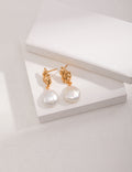 Vintage-gold sterling silver drop earrings with suspended natural baroque pearls.