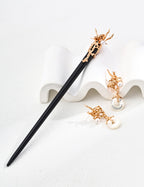 Purple sandalwood hairpin with sterling silver detailing and natural pearl accents.