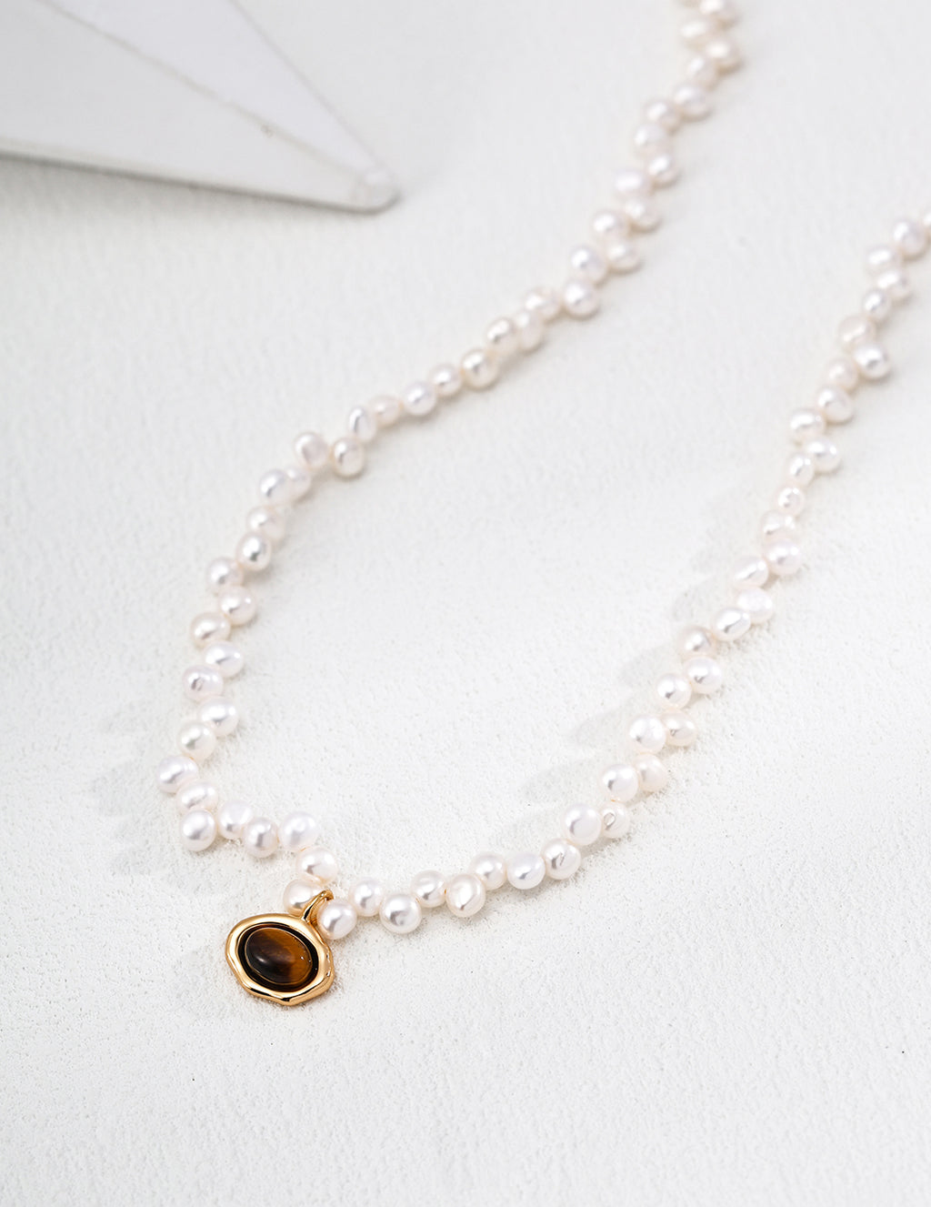 Vintage-gold sterling silver necklace with natural pearls and Tiger's Eye details.