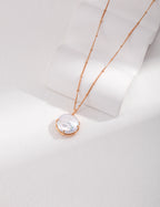 Vintage-gold sterling silver necklace with natural pearl details and a sculptural pendant composition.