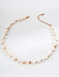 Vintage-gold sterling silver necklace with irregular natural pearls, polished spherical beads and scattered sculptural metal accents.