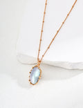 Vintage-gold sterling silver necklace with an oval iridescent Mabe pearl in an irregular sculptural metal surround.