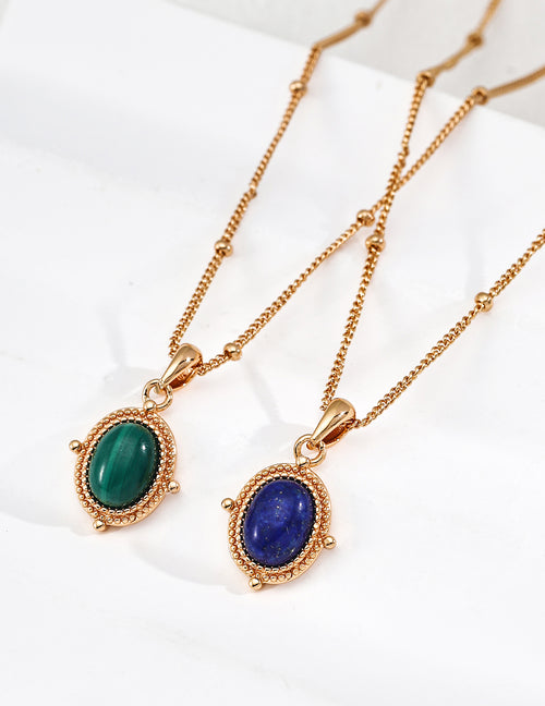 Vintage-gold sterling silver necklace with an oval blue lapis lazuli pendant in a finely textured beaded-edge frame.