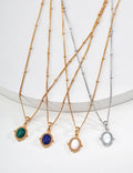 Vintage-gold sterling silver pendant necklace with an oval stone centerpiece in a softly irregular sculptural frame.