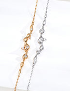 Vintage-gold sterling silver necklace with three cubic zirconia accents arranged asymmetrically among small fluid metal forms.