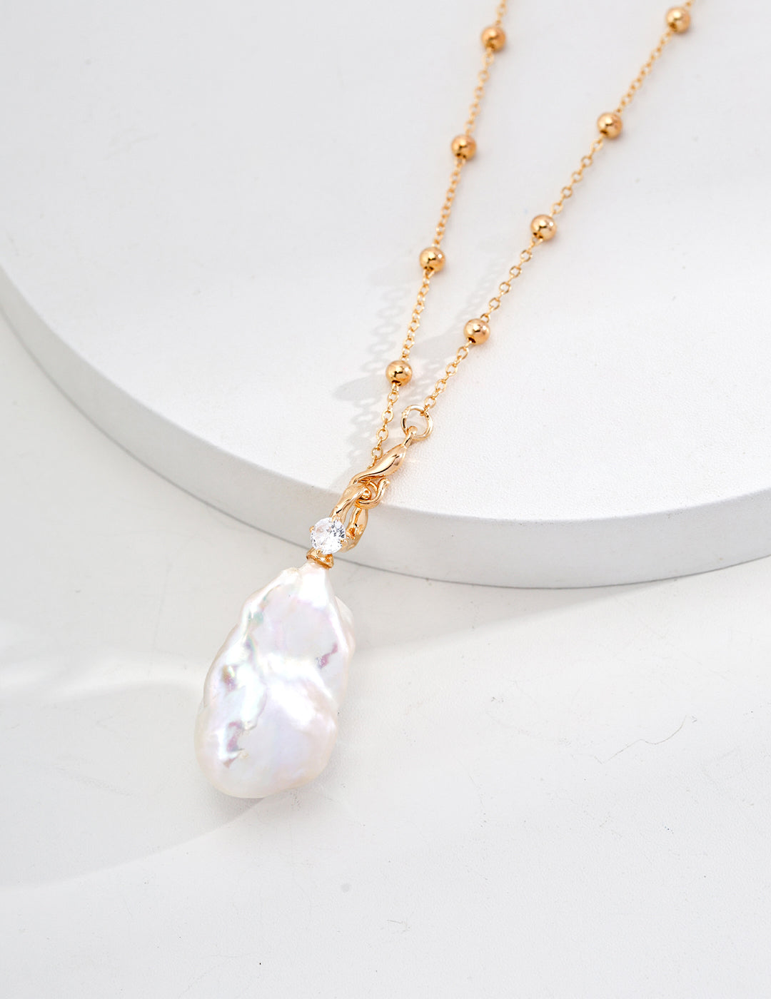 Vintage-gold S925 sterling silver necklace with natural baroque pearl and cubic zirconia detail.